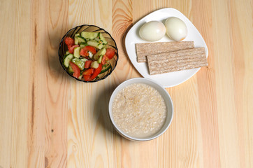 Fototapeta na wymiar two boiled eggs porridge useful breakfast