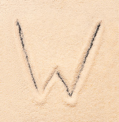 W letter written on sand