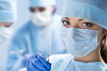 Close-up portrait of young female surgeon doctor