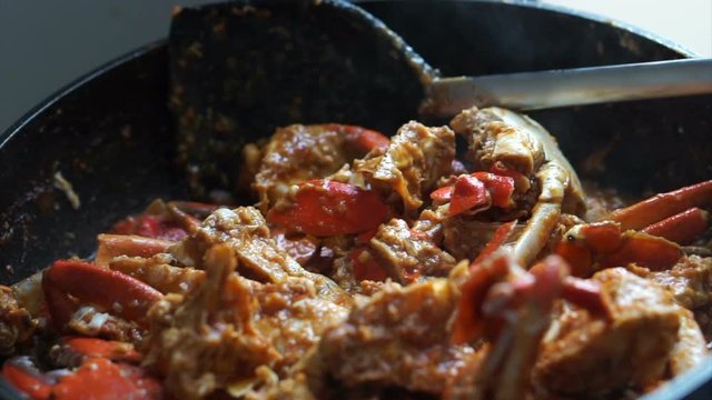 Cooking Singaporean signature dish, Chilli crab. Popular seafood dish 