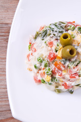 vegetable salad in a bowl on wooden background