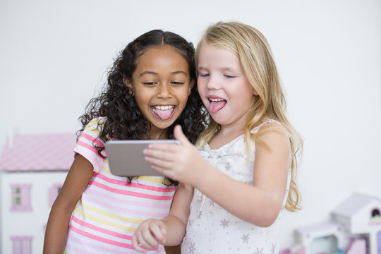 Two girls taking selfies