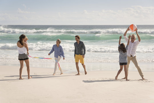 Happy multi-generation family enjoying on beach