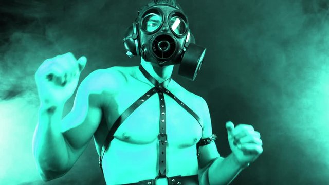 muscular man dancing wearing a gas mask