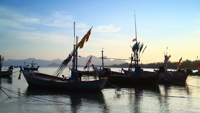 Group of fishing boat anchored at Pranburi beach in Thailand, taken on twilight sunset scene