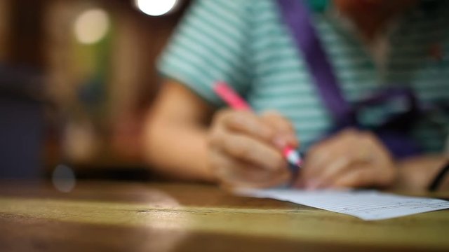 old woman writing on paper