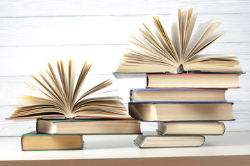 Open book, hardback books on wooden table. Education background. Back to school. Copy space for text.