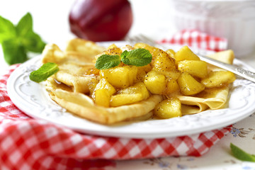 Thin pancakes with caramelised apples and cinnamon.
