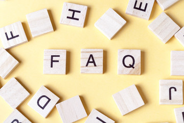 FAQ word written on wood block. Wooden ABC