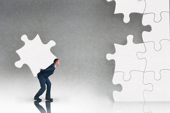 business puzzle concept with businessman and jigsaw