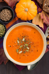 pumpkin soup in wooden bowl, top view