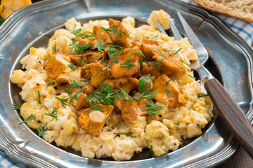 scrambled eggs with chanterelles and fresh dill, close-up