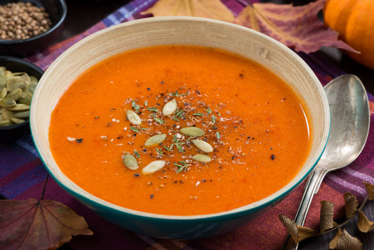 pumpkin soup in a bowl on table