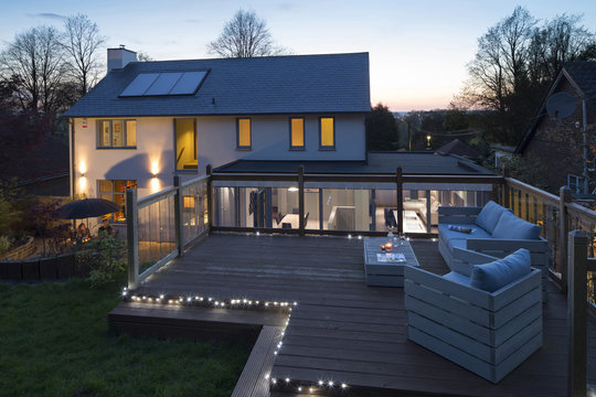 Deck at dusk with outdoor furniture and candles