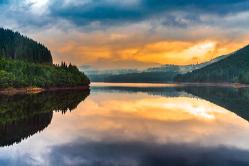 Lake Oasa at sunset in Romania