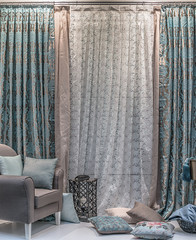 A cozy interior in turquoise and beige tones. A combined curtains, a translucent tulle, the pillows...
