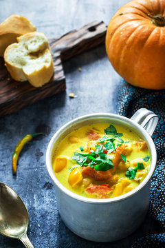 Pumpkin soup  on blue background. Selective focus.