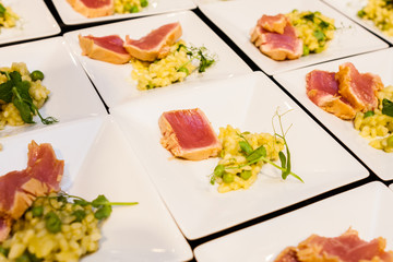 crispy fried tuna fillet with vegetables on white plate