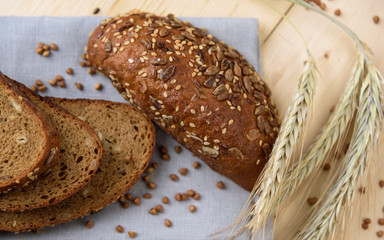 Fresh crusty bread on the plate and wheat ears