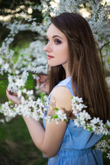 Fototapeta premium portrait of beautiful woman in summer garden