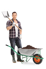 Male gardener holding a shovel