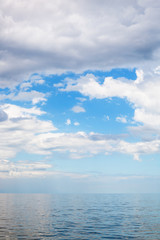 Obraz premium cumulus clouds over calm blue water Sea of Azov