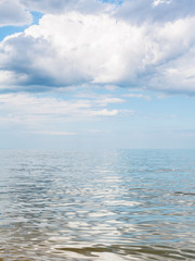Fototapeta na wymiar big white cloud over calm water of Azov Sea