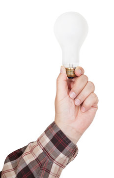 male hand holds incandescent lamp isolated