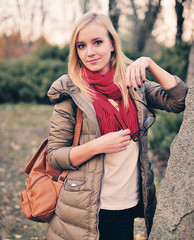 Fototapeta na wymiar Beautiful girl student with a backpack, glasses, outdoors.