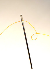 Needle and thread, close-up shot. Sewing background.