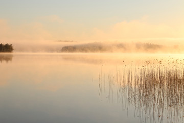 Sunrise on the lake with haze.