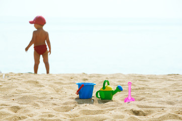 kids toys and little girl in the background on the seafront