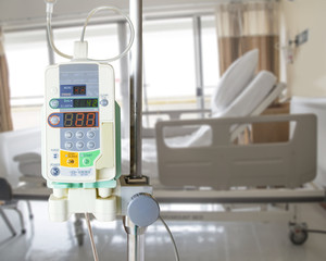 Automatic infusion pump and IV hanging on pole in hospital