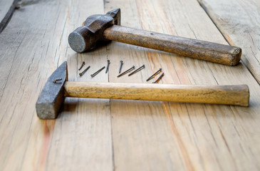 Hammer and nails on wood table background