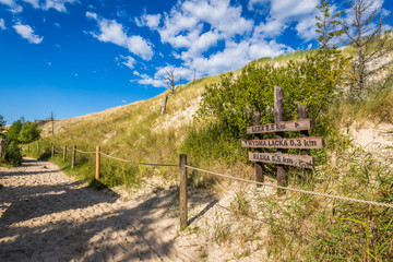 Sand dune tourist trail sign wooden gate to Wydma Lacka -  Slowi