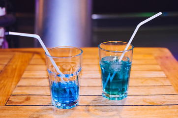 Blue cocktail on bar background