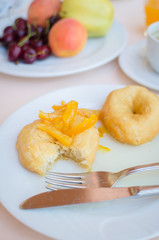 Breakfast including donuts with candied orange jam