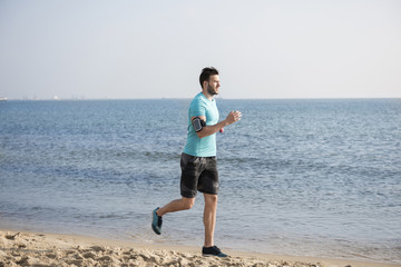 Fototapeta na wymiar Man jogging close to the sea