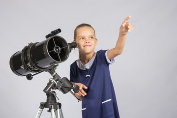 The young astronomer pointing at the starry sky