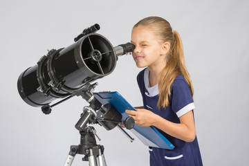 The young astronomer happy to look through the telescope recording observations - obrazy, fototapety, plakaty
