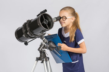 The young astronomer happy to look through the telescope recording observations