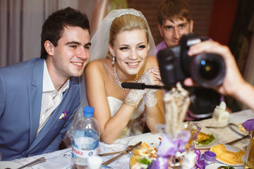 Newlyweds are watching photos on the wedding party