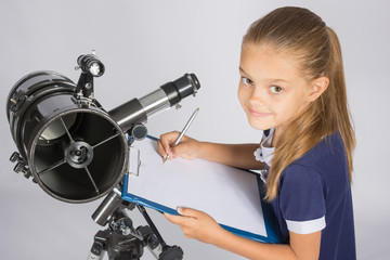 Young Astronomer writes the results of observations in the document