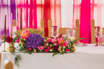 Fototapeta na wymiar Beautiful table set with candles and flowers for a festive event, party or wedding reception