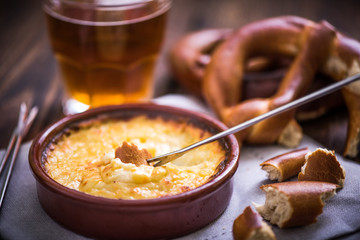 worming cheese fondue with pretzel at winter