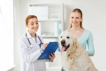 happy doctor with retriever dog at vet clinic