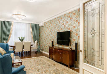 interior of a room with a TV, desk and chairs