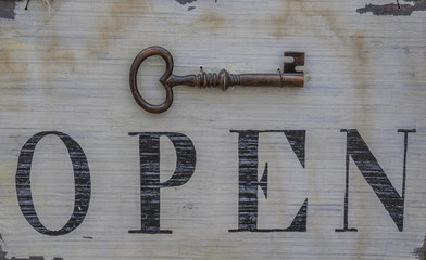 Old key on wooden door close up
