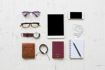 Travel concept with men's accessories and passport on white rustic wooden background