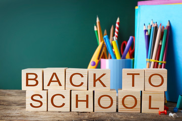 Colourful stationery and words BACK TO SCHOOL on table